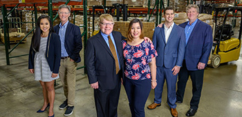Six individuals from the Butter Buds® teams standing in a warehouse.
