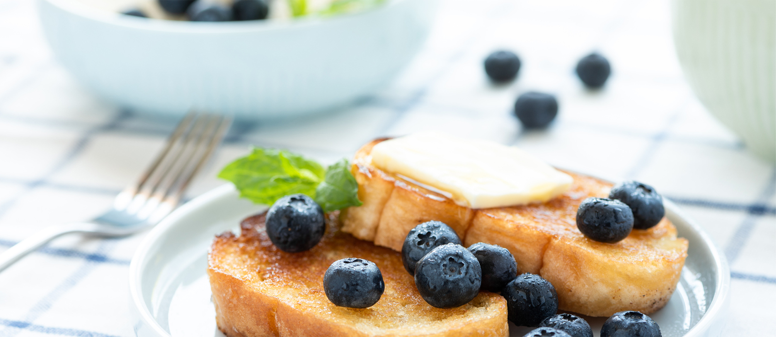plate of toast with butter and blueberries