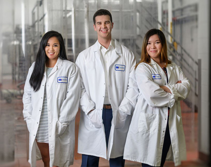 three people with lab coats